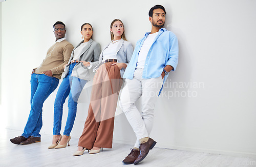 Image of Creative people, relax and waiting room on wall for recruiting, opportunity or thinking at office. Group of employees standing and leaning in row for hiring, team diversity or startup at workplace