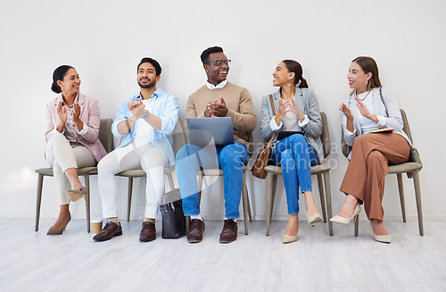 Image of Business people, presentation and applause with smile in waiting room for interview, recruitment or we are hiring in a row. Men, women and group together for process, career and resume at company