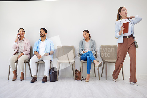 Image of People, waiting room and businesswoman walking to interview at job recruitment agency. Human resources, hiring and diversity, men and women in lobby together with professional career opportunity.