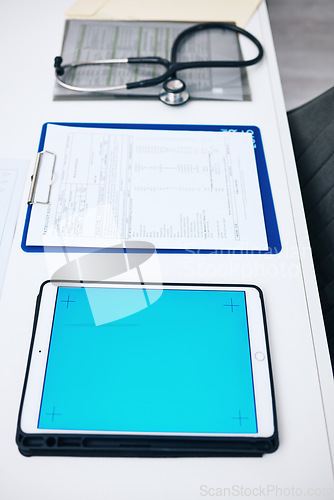Image of Tablet mockup, screen and hospital desk, healthcare background and documents for medical services. Digital technology, blue space and paperwork with empty clinic for registration, report or charts