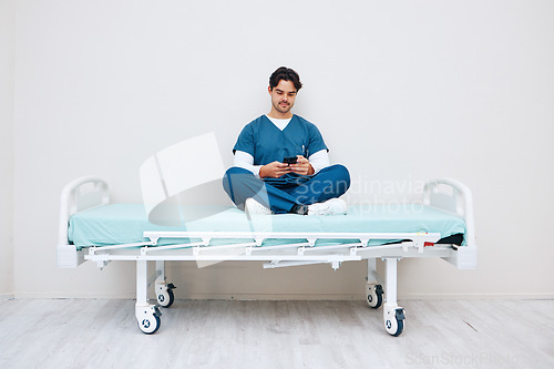 Image of Phone, nurse and man typing on bed in hospital, telehealth or relax on break on mockup space. Smartphone, stretcher and medical professional on internet, social media or communication on health app