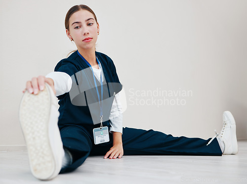 Image of Stretching, legs and nurse with feet on floor in exercise, pilates or start of shift in clinic and healthcare. Work, preparation and warm up body for wellness, meditation and fitness in hospital