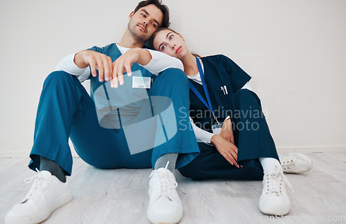 Image of Sad doctors, hospital floor and woman with man, support and lost with regret, death and fail in surgery. Medic, partnership and burnout with depression, mistake or anxiety for healthcare in clinic