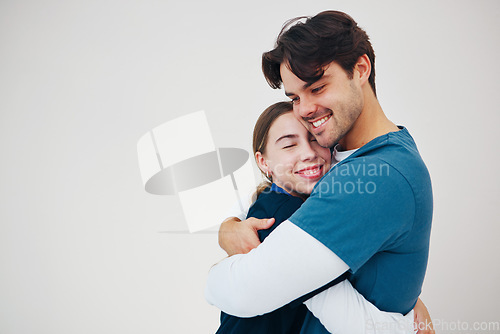 Image of Doctor, colleagues and hug happy at healthcare clinic, support or work. Medical professional, couple of friends or helping comfort or team in scrubs on white background, mockup or trust at hospital