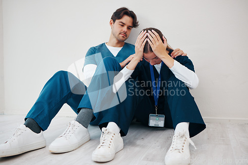 Image of Crying doctors, clinic floor and woman with man, support or empathy for regret, death or fail in surgery. Medic, partnership and burnout with depression, mistake or anxiety for healthcare in hospital