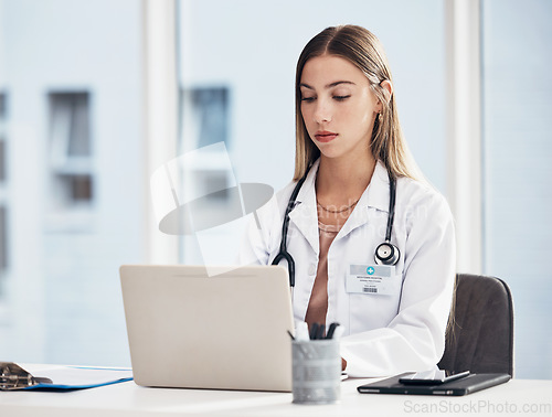 Image of Doctor, woman and laptop for hospital research, medical study and planning for telehealth or clinic report. Healthcare worker or student working on computer for website information, review or service