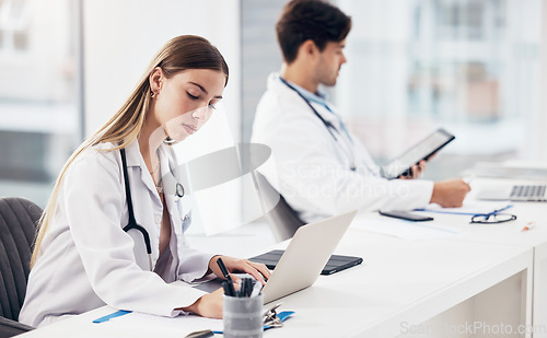 Image of Doctors, healthcare and coworkers working at desk for planning, research and medical schedule at workspace in hospital. Medicine, man and woman with collaboration, teamwork or brainstorming results