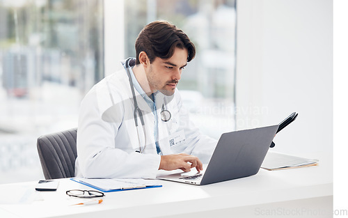 Image of Laptop, news or doctor with research, medical update or telehealth web service in hospital clinic. Man, science or surgeon working in professional healthcare typing on digital tech for email info