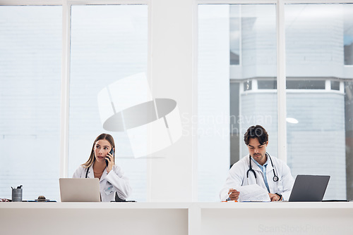 Image of Doctors, team and hospital phone call, planning or communication for telehealth services or clinic research. Medical people working in office or reception desk with laptop, documents and mobile chat