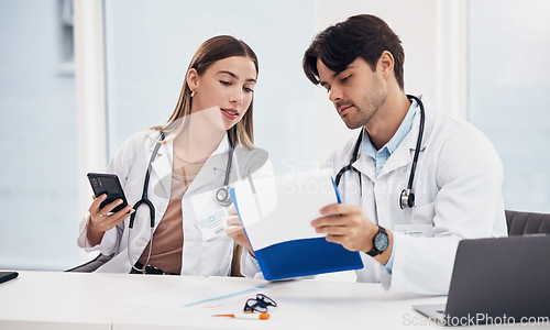 Image of Doctors, healthcare and working together with clipboard for planning, research and medical schedule at desk in hospital. Medicine, man and woman with collaboration, teamwork or brainstorming results