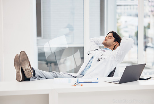 Image of Man, doctor and sleeping in relax for done, completion or finished at hospital office. Tired male person or medical surgeon chilling on break, rest or asleep lying with feet on work desk at clinic