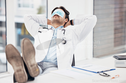 Image of Man, doctor and sleeping with face mask on break or relax for done, completion or finished at hospital office. Tired male person or medical surgeon chilling for rest or asleep on work desk at clinic