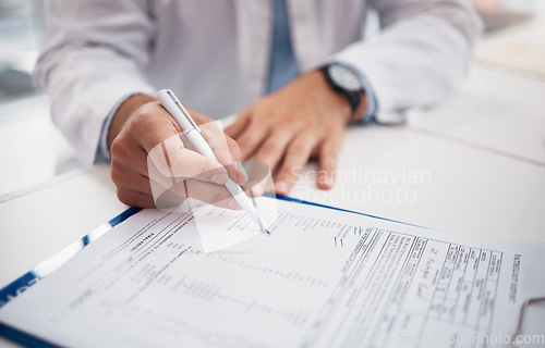 Image of Closeup, doctor and hands with document for writing on insurance form, information or chart of patient for treatment. Healthcare professional, nurse or specialist with clipboard for medical history