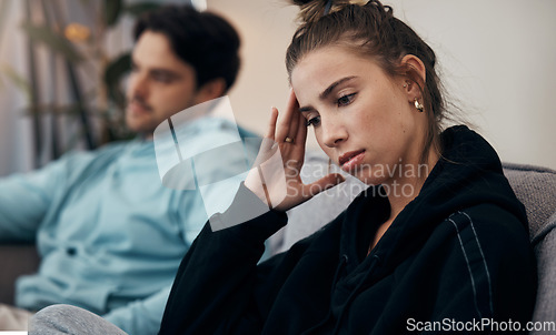 Image of Frustrated couple, headache and fight on sofa in divorce, disagreement or conflict in living room at home. Man and woman in toxic relationship, cheating affair or dispute on lounge couch at house