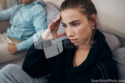 Image of Divorce, stress and angry couple on a sofa after fighting, argue or infertility problem at home. Marriage, conflict and frustrated woman in living room overthinking, anxiety or sad with cheating man