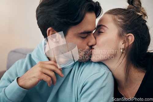 Image of Couple, relax and kiss on sofa with love in home, living room or house with happy, partnership or marriage. Romantic, people and bonding with man and woman in affection for support and care together