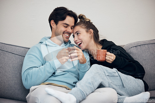 Image of Couple, tea and relax with smile, love and trust on sofa in living room of home or apartment with bonding. Coffee, man and woman together with happiness for peace, romance and commitment on couch