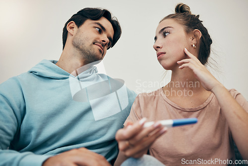 Image of Couple, pregnancy test and stress in home for infertility, anxiety or support. Woman, or male person or frustrated ovulation news or waiting information fear for loss, relationship problem or comfort