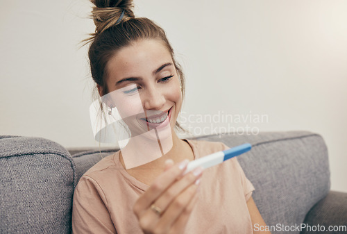 Image of Pregnancy test, smile and woman on sofa in home, reading good news and check positive results. Pregnant, stick and happy mother in living room excited for success, future maternity and ivf fertility