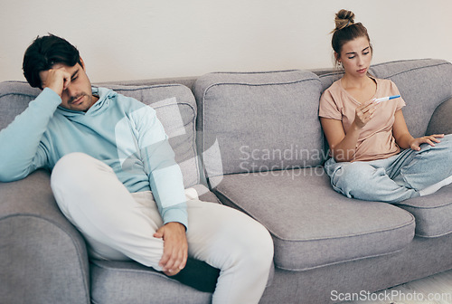 Image of Pregnancy test, stress and couple on a sofa angry, fighting or argue in their home. Pregnant, conflict and frustrated people in a living room upset with infertility criss, loss or ivf treatment fail