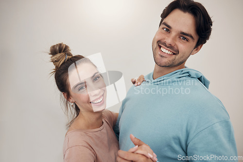 Image of Portrait, smile and couple dance in a house with music, fun and bonding in their home. Face, hug and happy people dancing to podcast, radio or hifi, laughing and enjoy relationship on wall background