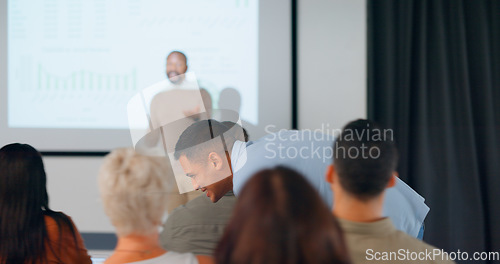 Image of Conference, presentation and man whisper in audience of training workshop, entrepreneur training and seminar. Business, people and speaker or coach share knowledge, information or strategy in meeting