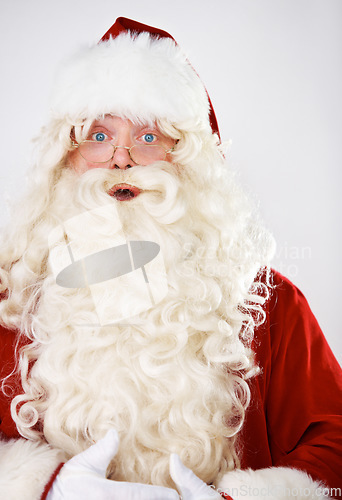 Image of Santa claus, surprise and portrait in studio for Christmas celebration, season greeting or vacation joy. Male person, shock emoji face and red costume for holiday traditions, event or wow fun mockup