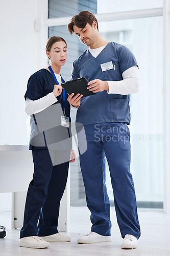 Image of Healthcare, man and woman with tablet in office at hospital with research, advice and teamwork. Medical professional, nurse and doctor with digital app for telehealth, insurance website and schedule.