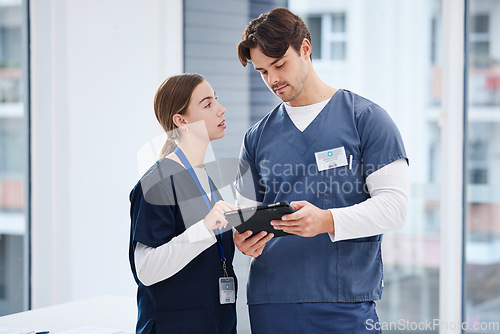 Image of Doctors, man and woman with tablet at hospital with discussion, healthcare and teamwork. Medical professional, nurse and surgeon with digital app for telehealth, insurance website and clinic advice