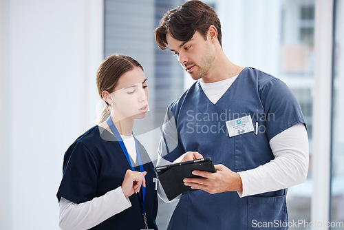 Image of Healthcare, doctor and nurse with tablet, discussion and schedule at hospital with teamwork. Medical professional, man and woman with digital app for telehealth, health insurance website and advice.