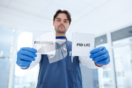 Image of Life, choice and doctor with paper in hands for abortion, human rights or decision in clinic. Nurse, poster and support for women with option of family planning in hospital or medical contraception