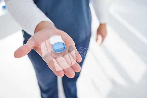 Image of Health, eye care and hand of doctor with contacts in case for vision, help with eyesight and advice. Eyecare, solution and man giving lenses in container for eyewear, choice and option for sight.