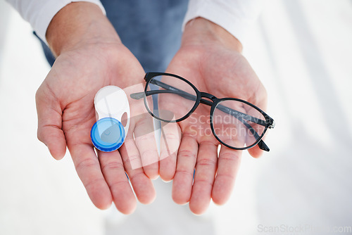 Image of Eye care, hands of doctor with glasses and contact lens in case for vision, help with eyesight and choice. Eyecare, decision and sight, man giving lenses in container and frame for eyewear option.