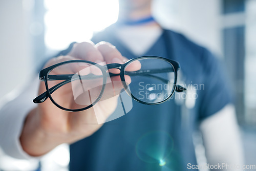 Image of Optometry, glasses and hands of optician with frames, prescription lens and spectacles for sight. Healthcare, ophthalmology and person in clinic for eye care, vision and medical service for wellness