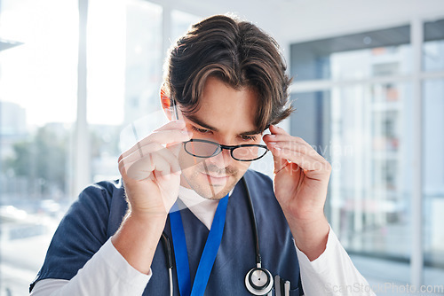 Image of Optometry, glasses and man in clinic with frame, prescription lens and spectacles for eyesight. Healthcare, ophthalmology and face of doctor for eye care, vision and medical service for wellness