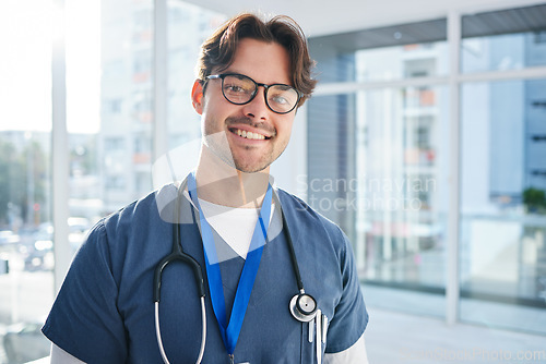 Image of Man, doctor and hospital for healthcare, portrait and smile for career, confident and mindset. Services, medical and professional with confidence, male and work for medicare clinic, insurance and job