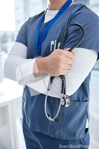 Image of Stethoscope, doctor arms crossed and hospital person, nurse or cardiologist for heartbeat, breathing or health exam. Healthcare trust, closeup surgeon hands and nursing medic for cardiology support