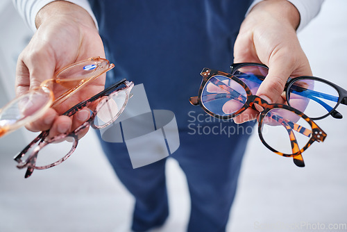 Image of Optometry, glasses and hands of person with option for frame, prescription lens and spectacles for sight. Healthcare, ophthalmology and optician with decision for eye care, vision and medical clinic