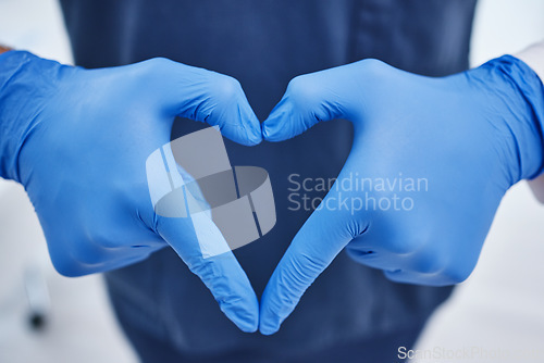 Image of Gloves, hospital and hands in heart of doctor for medicine, surgery and working in clinic for wellness. Healthcare, emoji and person with ppe for safety, insurance and support for medical service
