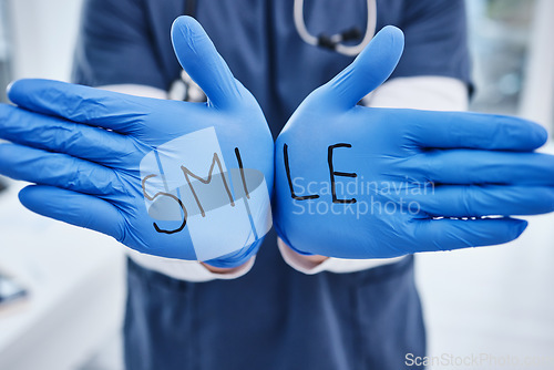 Image of Healthcare, message and hands of a doctor with gloves for a smile, medical safety and information. Showing, surgery and a nurse or surgeon with words for motivation, health and support at a clinic