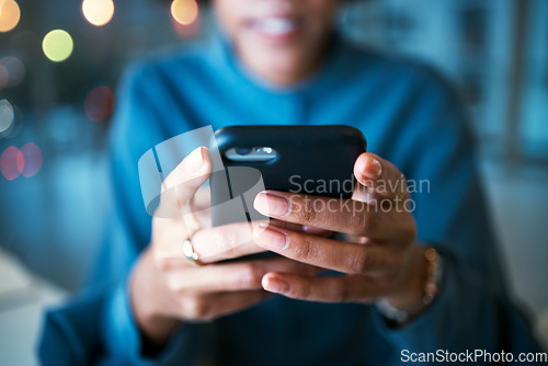Image of Night, hands and business person with phone in office for social media, text or chat communication. Working late, message and female entrepreneur with smartphone app for internet, search or reading