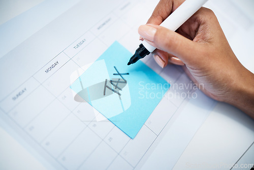 Image of Hand closeup, notes and tax on calendar with finance, law and compliance for money administration. Person, writing and pen with reminder, schedule and date for audit, agenda and paper for profit