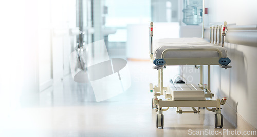 Image of Healthcare, medical and a bed in the corridor of a hospital after work, ready for an emergency or accident. Medicine, wellness and service with a gurney in the empty hallway of a health clinic