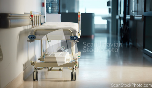 Image of Healthcare, medicine and a bed in the hallway of a hospital after work, ready for an emergency or accident. Medical, wellness and service with a gurney in the empty corridor of a health clinic