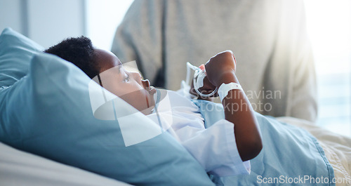 Image of Sick black kid in hospital at bed for healthcare, recovery from virus or healing injury in pediatric clinic. Disease, illness and African child resting or patient in bedroom in medical rehabilitation