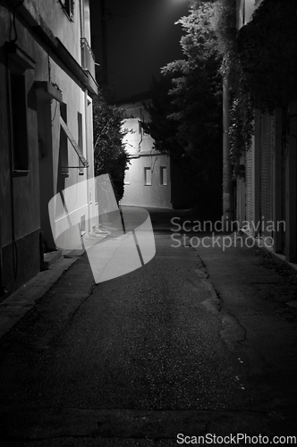 Image of dark alley and houses at night
