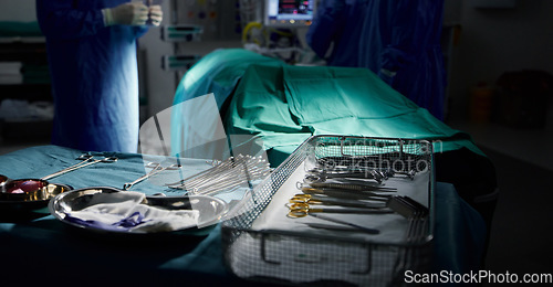 Image of Healthcare, medical and tools for surgery in the theater of a dark hospital for an operation or procedure. Medicine, equipment and emergency treatment with surgical metal in an operating room