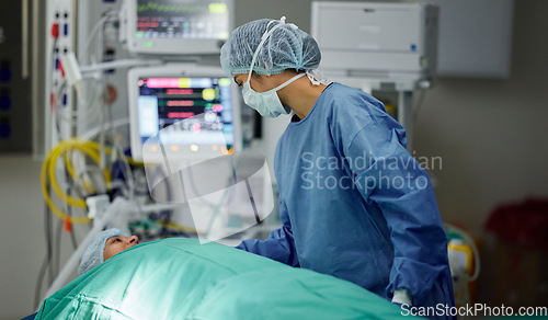 Image of Bed, theatre or doctor with patient in surgery procedure or healthcare operation in hospital clinic. Accident injury, people or surgeon in face mask helping in operating room in medical at night