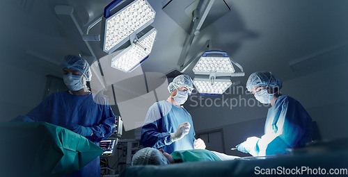 Image of Doctor, team and patient in surgery, people or emergency operation in theatre at hospital. Nurse or medical professionals working together in teamwork for surgical healthcare, doctors or service