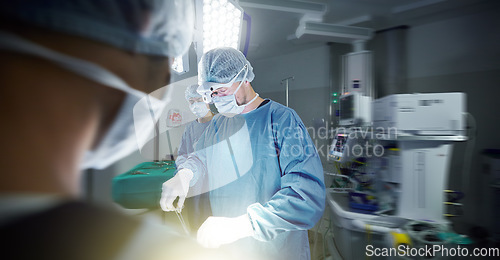 Image of Medical, teamwork and doctors in a hospital for surgery together, working in theater to save a life. Healthcare, emergency and a surgeon team in the operating room of a clinic for an operation